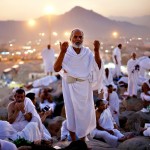 A Muslim pilgrim prays atop Mount Mercy on the plains of Arafat